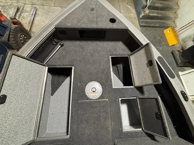 Slide: The Image of 2025 Crestliner 1750 Fish Hawk boat interior with open storage compartments. - 8