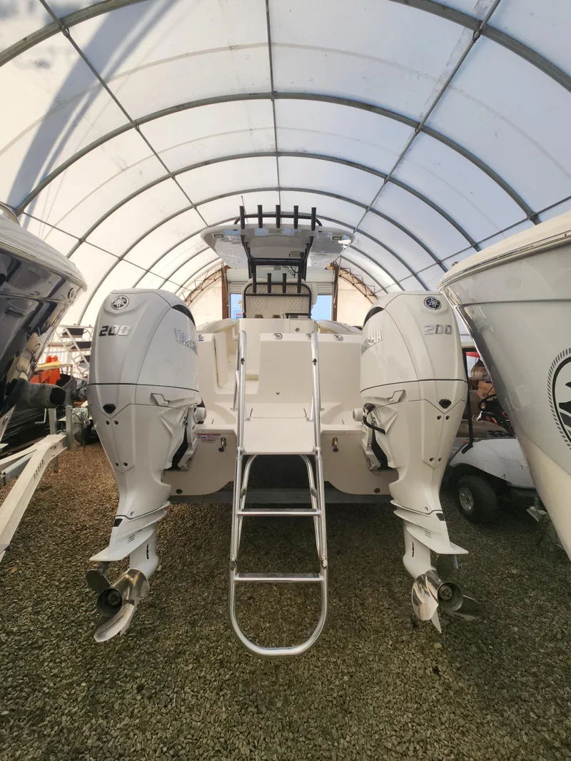 Slide: The Image of 2024 World Cat 280 CC-X boat with dual engines in covered storage. - 1