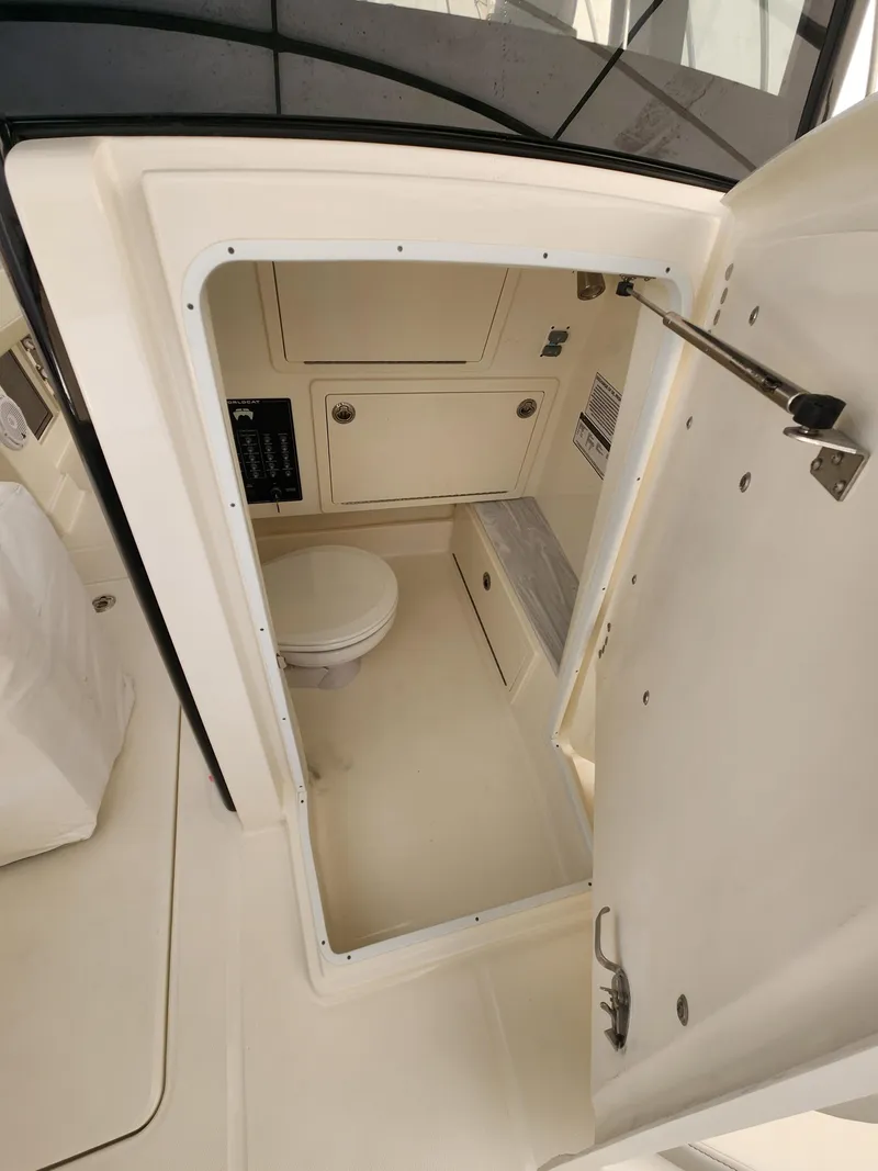 Slide: The Image of 2024 World Cat 280 CC-X boat interior with compact bathroom and storage. - 11