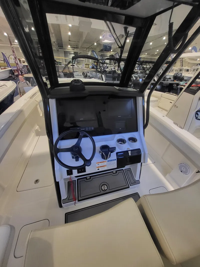 Slide: The Image of 2024 World Cat 280 CC-X boat interior with modern helm and steering wheel. - 6