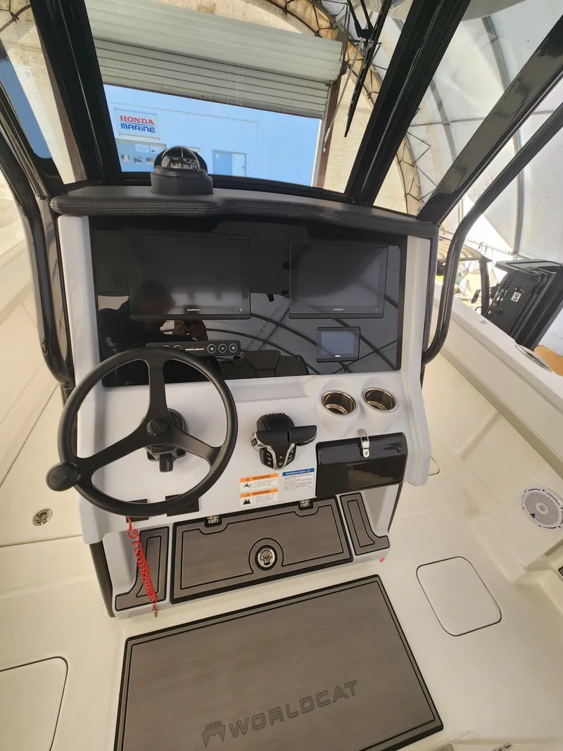 Slide: The Image of 2024 World Cat 280 CC-X boat cockpit with steering wheel and control panel. - 8