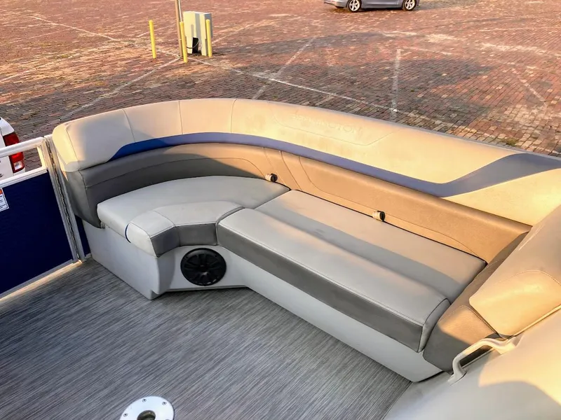 Slide: The Image of 2021 Bennington SX23 boat interior with gray seating and speaker. - 19