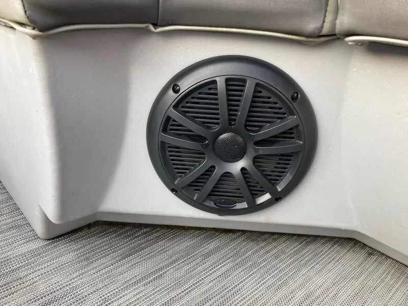Slide: The Image of Speaker on 2021 Bennington SX23 boat interior, featuring modern design and upholstery. - 23