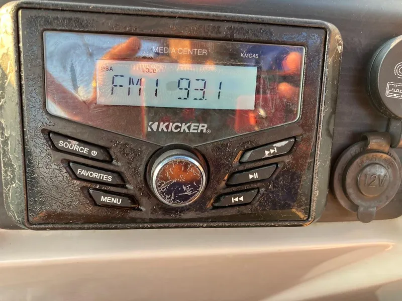 Slide: The Image of Kicker media center displaying FM 93.1 in a 2021 Bennington SX23 boat. - 29