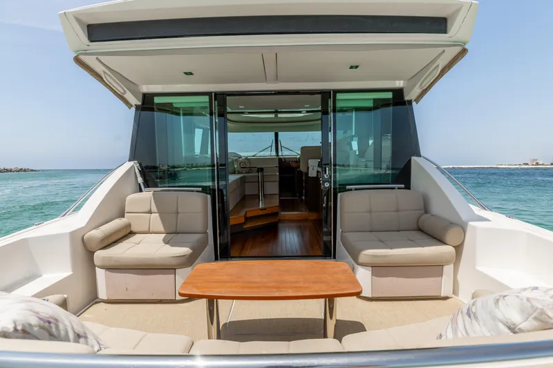 Slide: The Image of 2015 Tiara Yachts 44 Coupe with spacious outdoor seating and ocean view. - 2