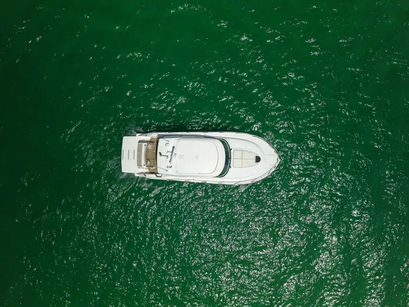 Slide: The Image of Overhead view of 2015 Tiara Yachts 44 Coupe on vibrant green water. - 31