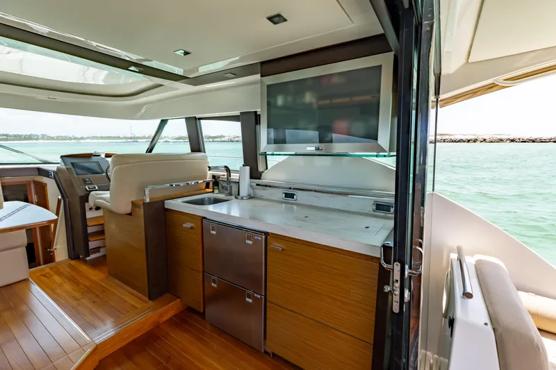 Slide: The Image of Interior of 2015 Tiara Yachts 44 Coupe with modern kitchen and ocean view. - 5