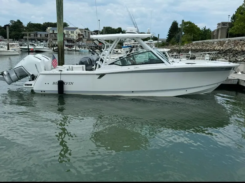 The Image of 2024 Blackfin 302 DC boat docked in a marina, showcasing sleek design and modern features. - 0