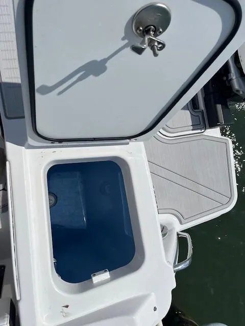 Slide: The Image of 2024 Blackfin 302 DC boat docked in a marina, surrounded by other vessels. - 11