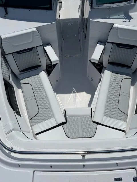 Slide: The Image of 2024 Blackfin 302 DC boat interior with cushioned seating and built-in speakers. - 14