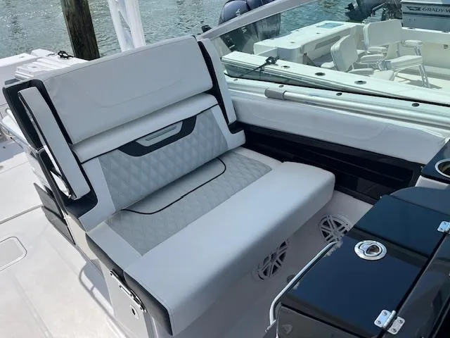 Slide: The Image of 2024 Blackfin 302 DC boat interior with sleek dashboard and cup holders. - 19