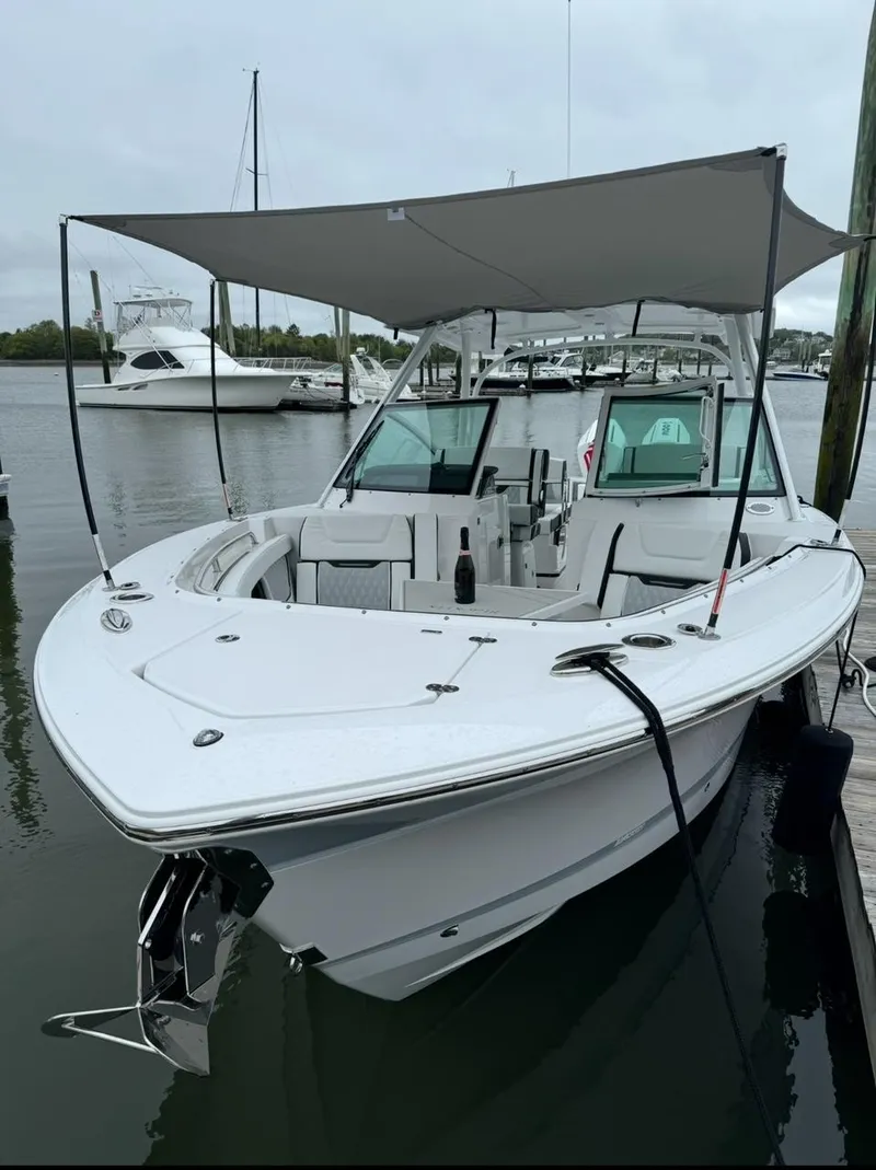 Slide: The Image of 2024 Blackfin 302 DC boat docked in a marina, sunny day. - 2