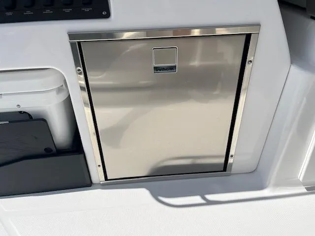 Slide: The Image of 2024 Blackfin 302 DC boat interior with cup holders and sleek design. - 28