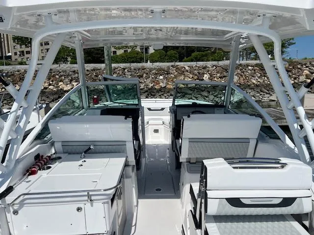 Slide: The Image of 2024 Blackfin 302 DC boat interior with cushioned seating and storage area. - 7