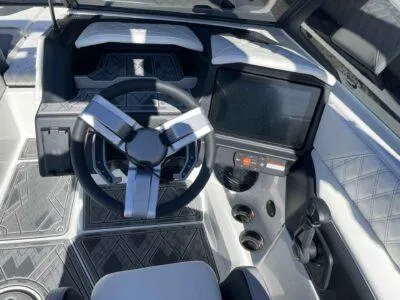 Slide: The Image of 2024 Tigé 22RZX boat dashboard with modern steering wheel and touchscreen display. - 12