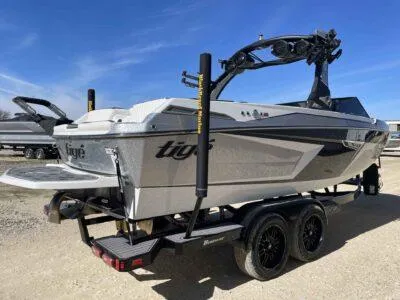 Slide: The Image of 2024 Tigé 22RZX boat on trailer, sleek design, sunny day. - 5