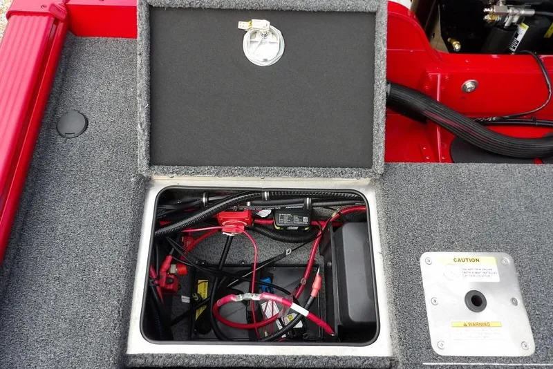 Slide: The Image of 2025 Lund 2075 Pro-V Bass XS battery compartment with wiring and caution label. - 10