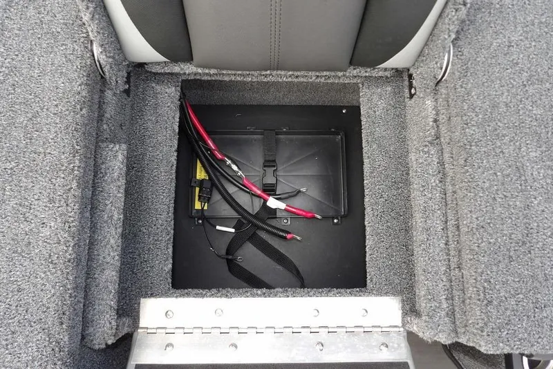 Slide: The Image of 2025 Lund 2075 Pro-V Bass XS battery compartment with wiring and secure straps. - 16