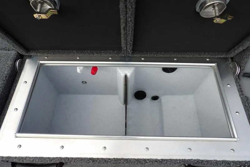 Slide: The Image of 2025 Lund 2075 Pro-V Bass XS livewell compartment, open and empty, with secure latches. - 17