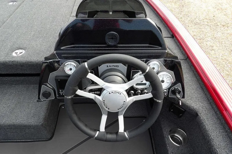 Slide: The Image of 2025 Lund 2075 Pro-V Bass XS boat dashboard with steering wheel and gauges. - 24