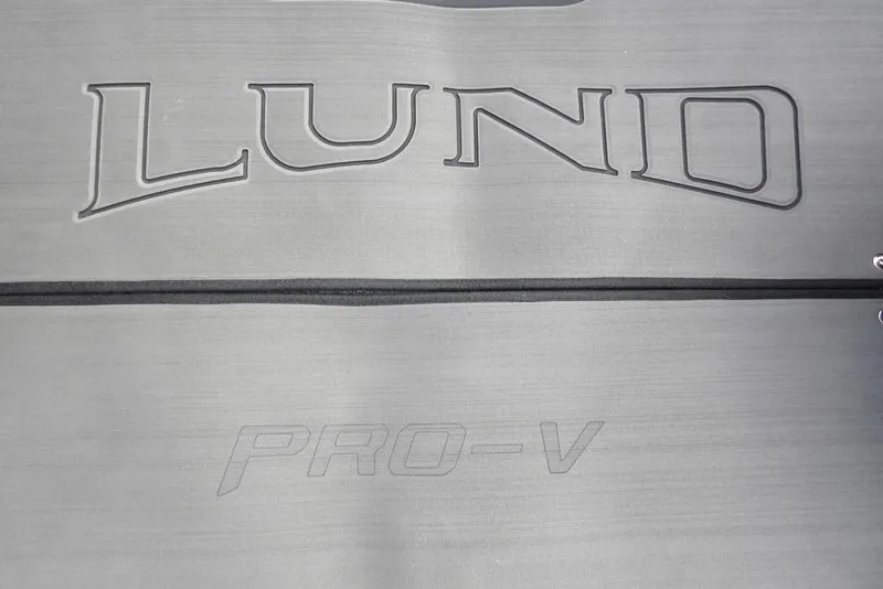 Slide: The Image of 2025 Lund 2075 Pro-V Bass XS logo on metallic surface. - 34