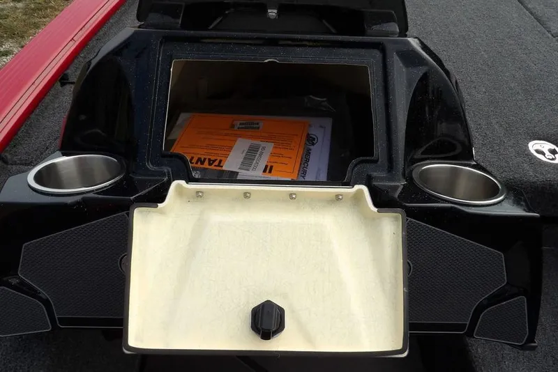 Slide: The Image of Open storage compartment on a 2025 Lund 2075 Pro-V Bass XS boat with cup holders. - 36
