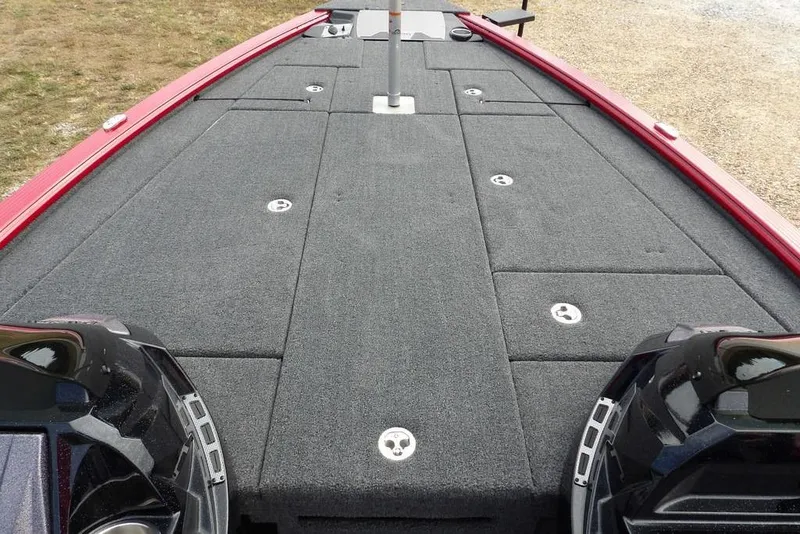 Slide: The Image of 2025 Lund 2075 Pro-V Bass XS boat deck with storage compartments and red trim. - 37