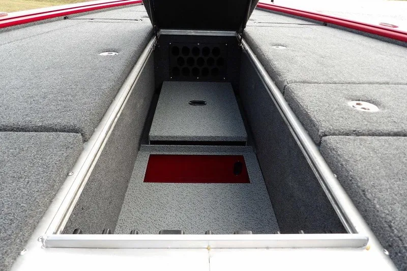 Slide: The Image of 2025 Lund 2075 Pro-V Bass XS boat storage compartment with carpeted interior. - 38