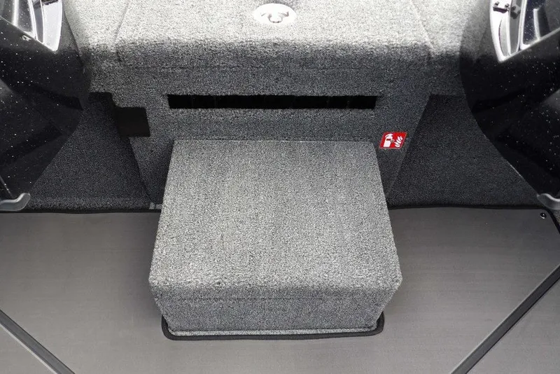 Slide: The Image of Interior of 2025 Lund 2075 Pro-V Bass XS boat, featuring carpeted step and storage area. - 41