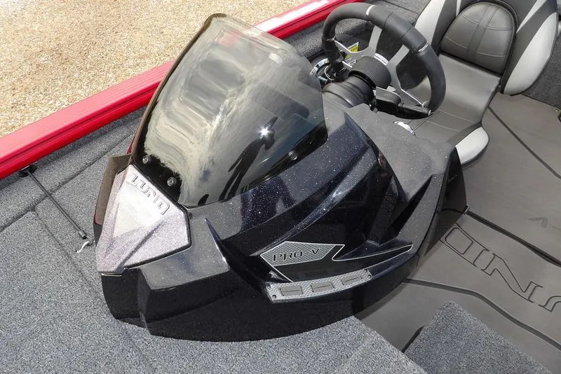 Slide: The Image of 2025 Lund 2075 Pro-V Bass XS boat cockpit with steering wheel and windshield. - 42