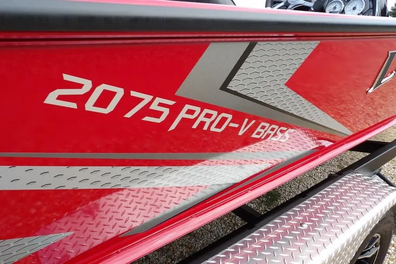 Slide: The Image of 2025 Lund 2075 Pro-V Bass XS boat with red and silver detailing. - 51