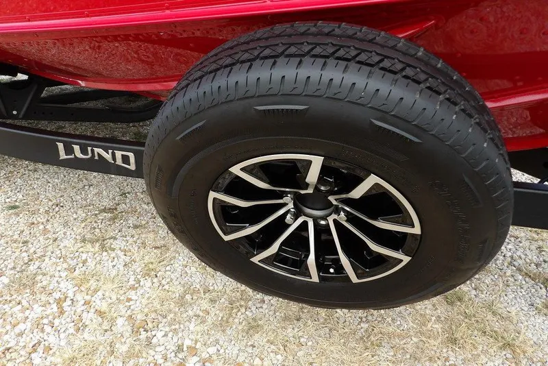 Slide: The Image of 2025 Lund 2075 Pro-V Bass XS trailer tire with stylish black and silver rim. - 57