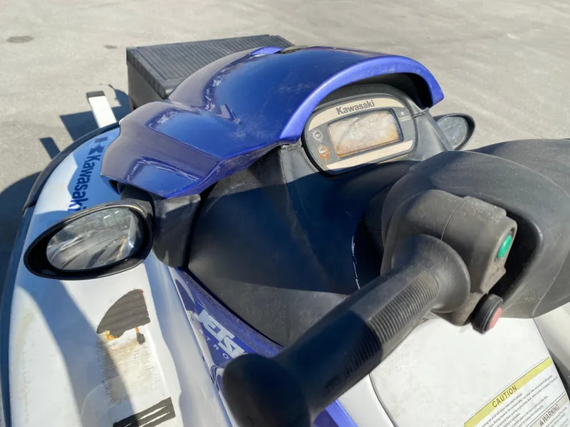 Slide: The Image of 2007 Kawasaki STX-12F jet ski dashboard and handlebars in close-up view. - 12