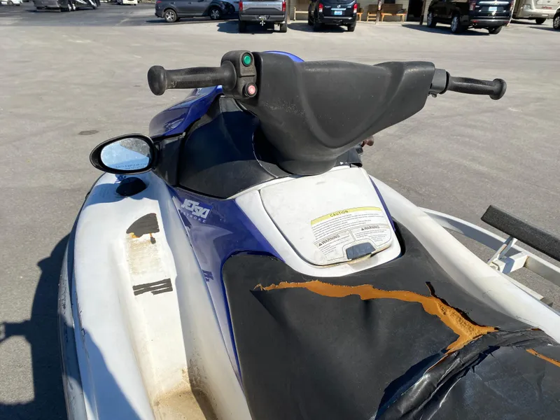 Slide: The Image of 2007 Kawasaki STX-12F jet ski with worn seat, parked in a lot. - 13