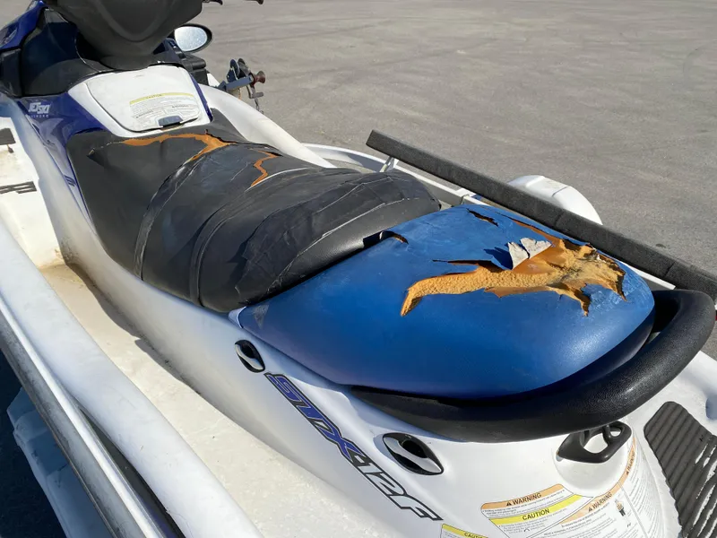Slide: The Image of 2007 Kawasaki STX-12F jet ski with torn seat upholstery on a trailer. - 14