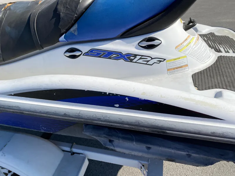 Slide: The Image of 2007 Kawasaki STX-12F jet ski on trailer, featuring blue and white design. - 16