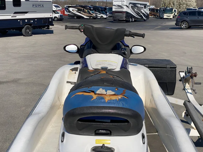 Slide: The Image of 2007 Kawasaki STX-12F jet ski with worn seat in a parking lot. - 18