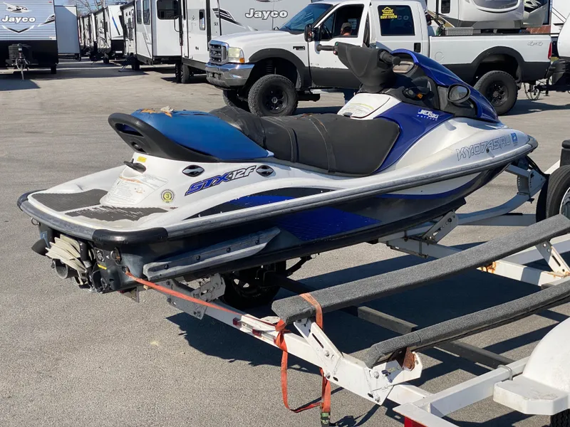 Slide: The Image of 2007 Kawasaki STX-12F jet ski on trailer, parked in a lot with RVs and trucks. - 22