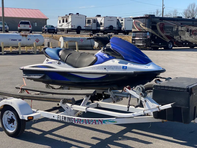 Slide: The Image of 2007 Kawasaki STX-12F jet ski on trailer in parking lot with RVs in background. - 25