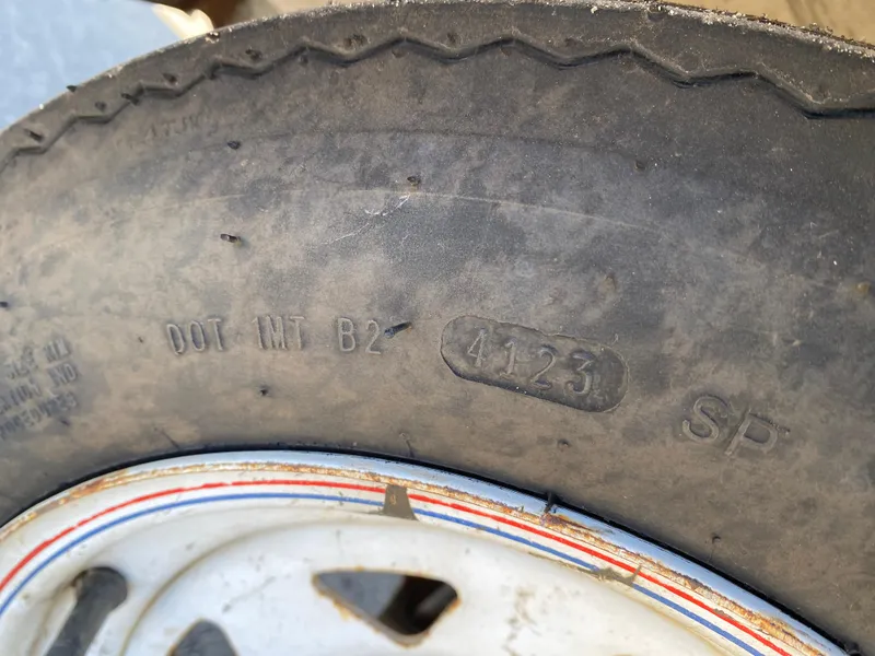 Slide: The Image of Close-up of a 2007 Kawasaki STX-12F tire with visible DOT code and tread details. - 29