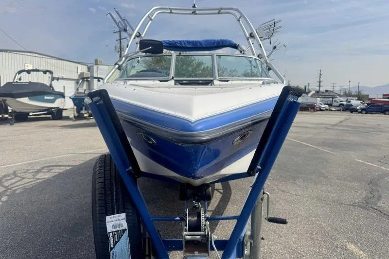 Slide: The Image of 2025 Lund 2075 Pro-V Bass XS boat interior with cup holders and storage compartment. - 16