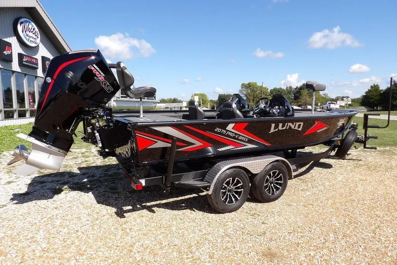 Slide: The Image of 2025 Lund 2075 Pro-V Bass XS boat interior with control panel and cup holders. - 28