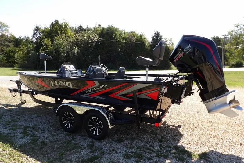 Slide: The Image of 2025 Lund 2075 Pro-V Bass XS boat interior with seating and console. - 29