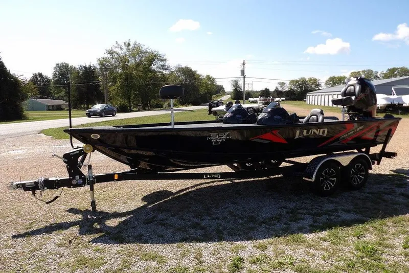 Slide: The Image of 2025 Lund 2075 Pro-V Bass XS boat interior with cup holders and storage. - 30