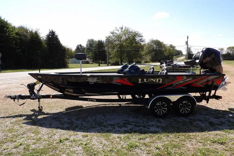 Slide: The Image of 2025 Lund 2075 Pro-V Bass XS boat with open storage compartment on deck. - 34