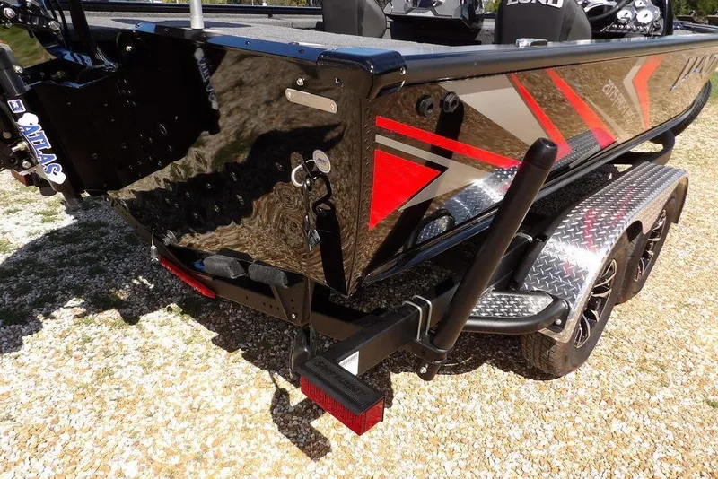 Slide: The Image of 2025 Lund 2075 Pro-V Bass XS boat on trailer, featuring sleek design and vibrant graphics. - 51