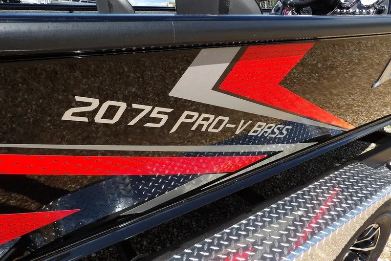 Slide: The Image of 2025 Lund 2075 Pro-V Bass XS boat with bold red and silver graphics. - 55