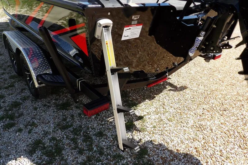 Slide: The Image of 2025 Lund 2075 Pro-V Bass XS boat with ladder on gravel surface. - 60