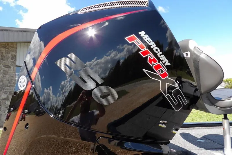 Slide: The Image of 2025 Lund 2075 Pro-V Bass XS boat with powerful outboard motor, parked on gravel. - 8