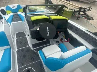 Slide: The Image of 2024 Tigé Z3 boat interior with blue and white seating, modern dashboard, and steering wheel. - 6